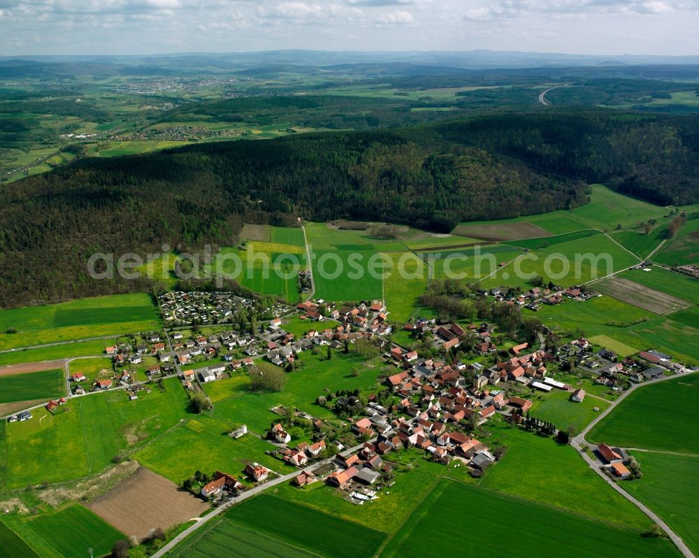 Aerial image Wehrda - Agricultural land and field boundaries surround the settlement area of the village in Wehrda in the state Hesse, Germany