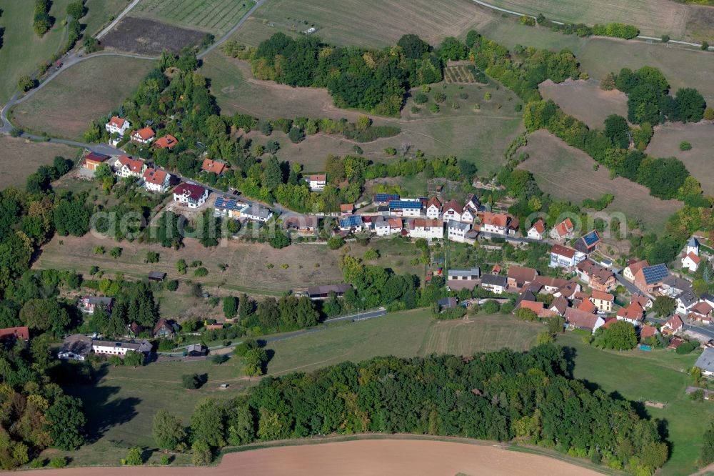 Weickersgrüben from above - Agricultural land and field boundaries surround the settlement area of the village in Weickersgrüben in the state Bavaria, Germany