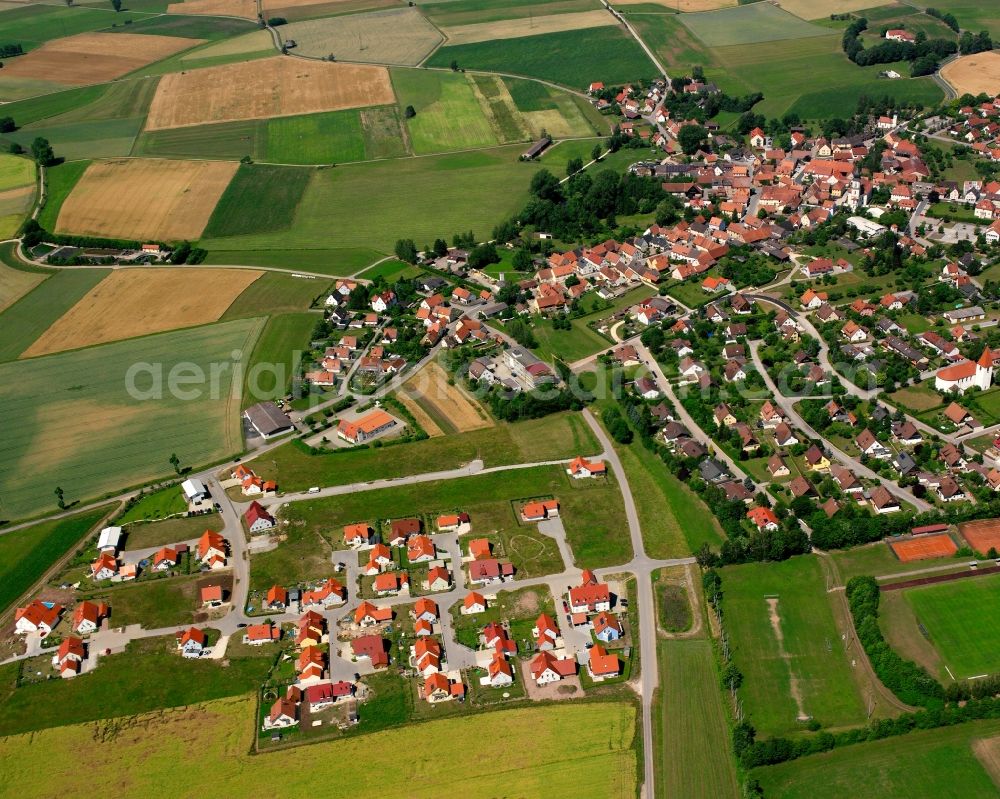 Weidenbach from above - Agricultural land and field boundaries surround the settlement area of the village in Weidenbach in the state Bavaria, Germany