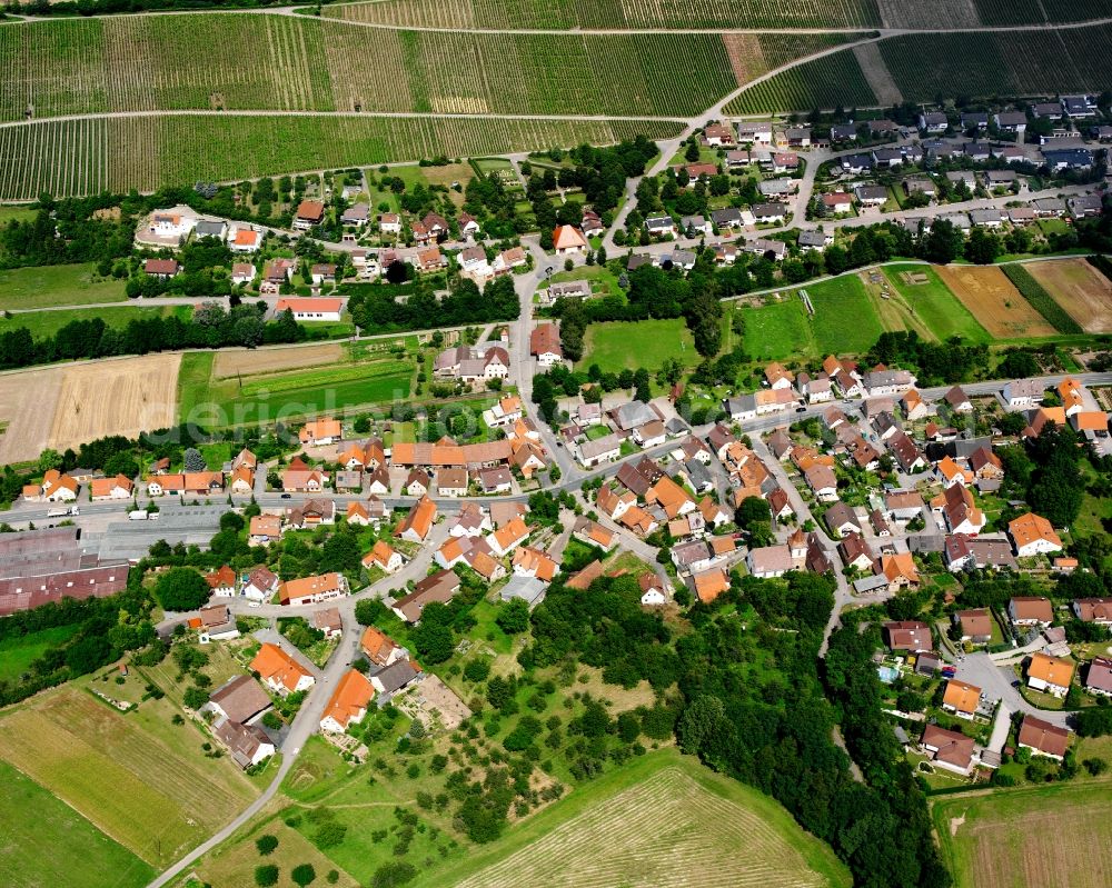 Weiler from above - Agricultural land and field boundaries surround the settlement area of the village in Weiler in the state Baden-Wuerttemberg, Germany