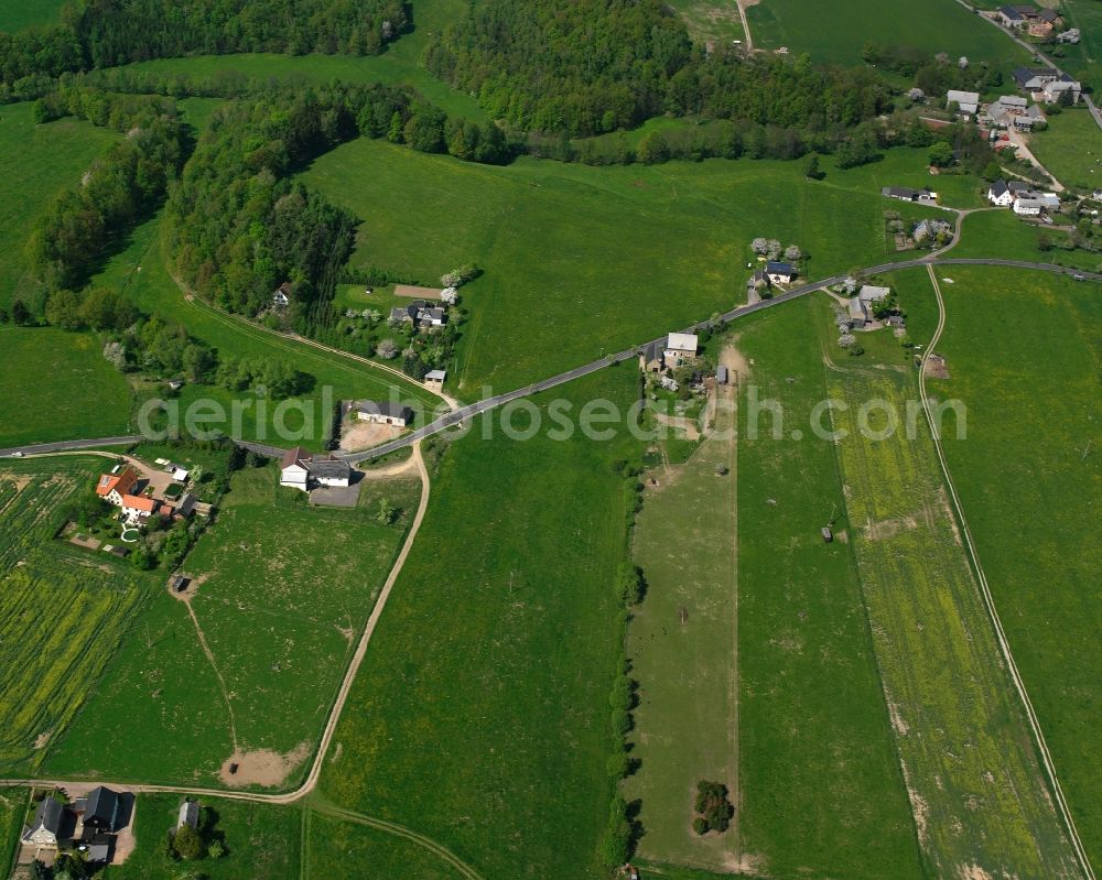 Weinsdorf from above - Agricultural land and field boundaries surround the settlement area of the village in Weinsdorf in the state Saxony, Germany