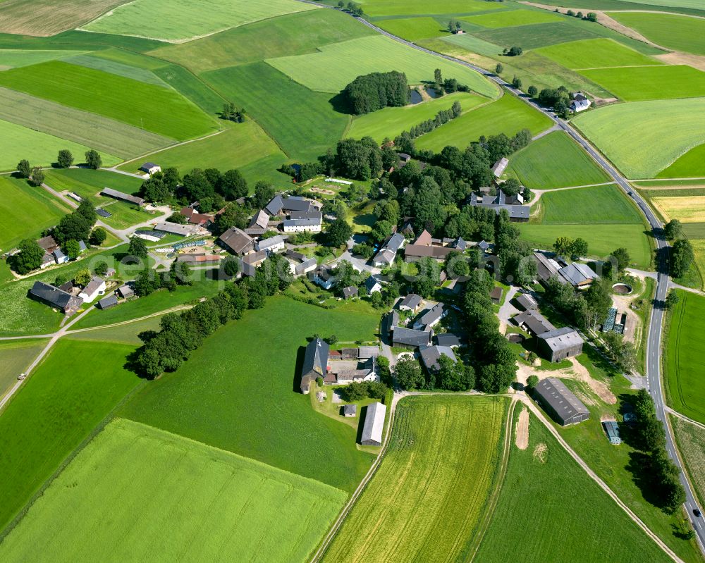 Weißdorf from above - Agricultural land and field boundaries surround the settlement area of the village in the district Wulmersreuth in Weissdorf in the state Bavaria, Germany