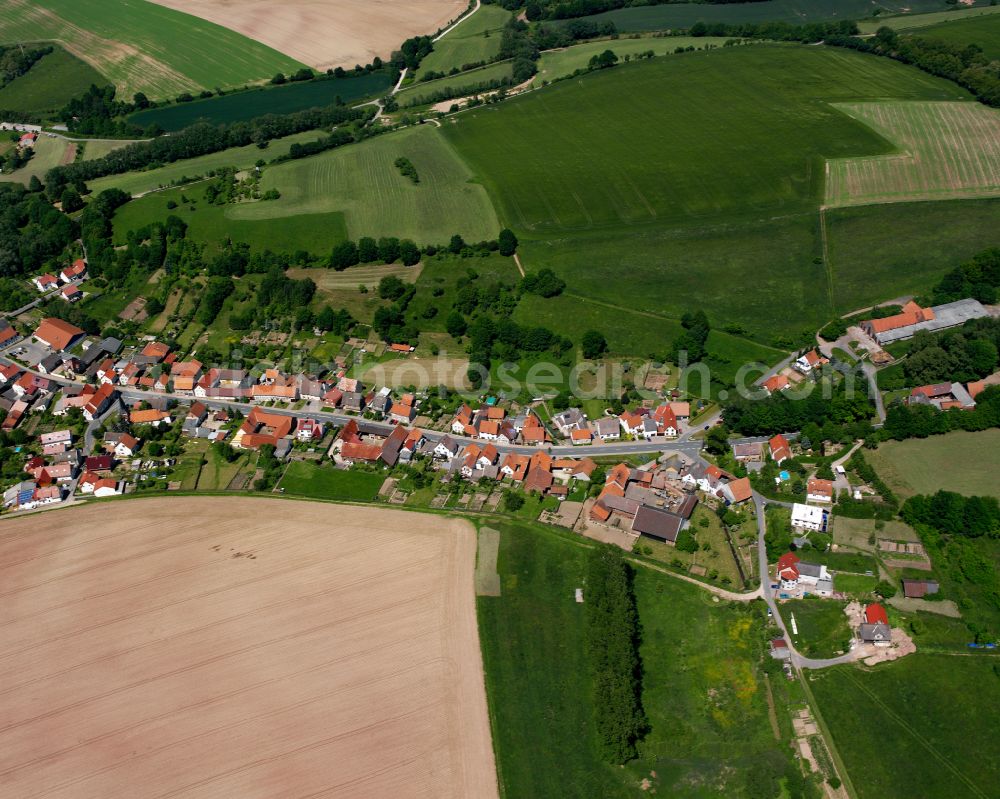 Weißenborn-Lüderode from the bird's eye view: Agricultural land and field boundaries surround the settlement area of the village in Weißenborn-Lüderode in the state Thuringia, Germany