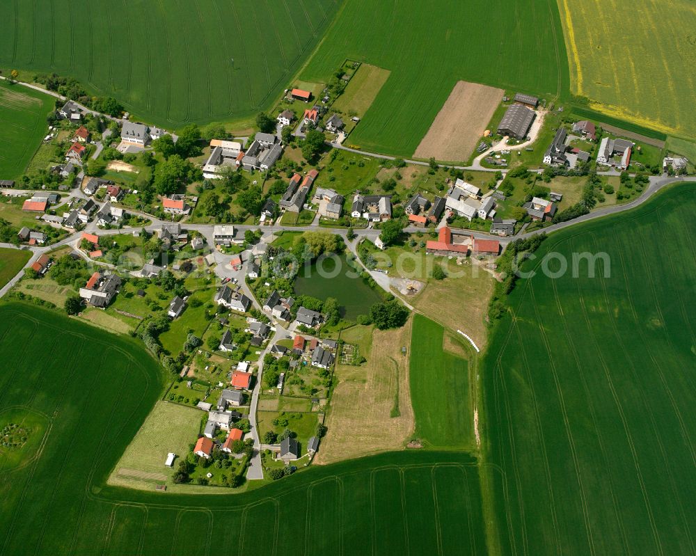 Wellsdorf from above - Agricultural land and field boundaries surround the settlement area of the village in Wellsdorf in the state Thuringia, Germany