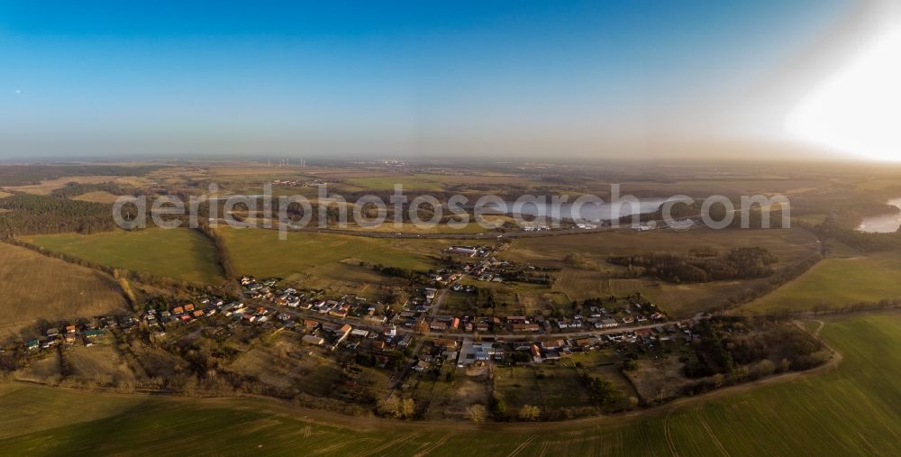 Werbellin from above - Agricultural land and field boundaries surround the settlement area of the village in Werbellin at Schorfheide in the state Brandenburg, Germany