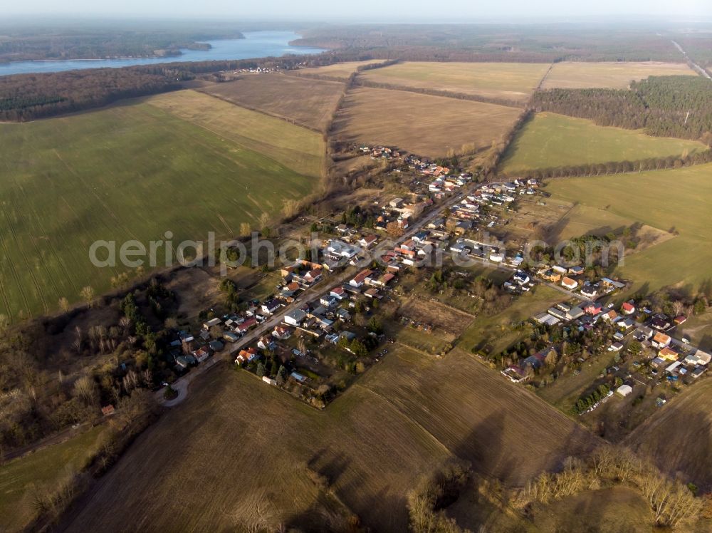 Werbellin from above - Agricultural land and field boundaries surround the settlement area of the village in Werbellin at Schorfheide in the state Brandenburg, Germany