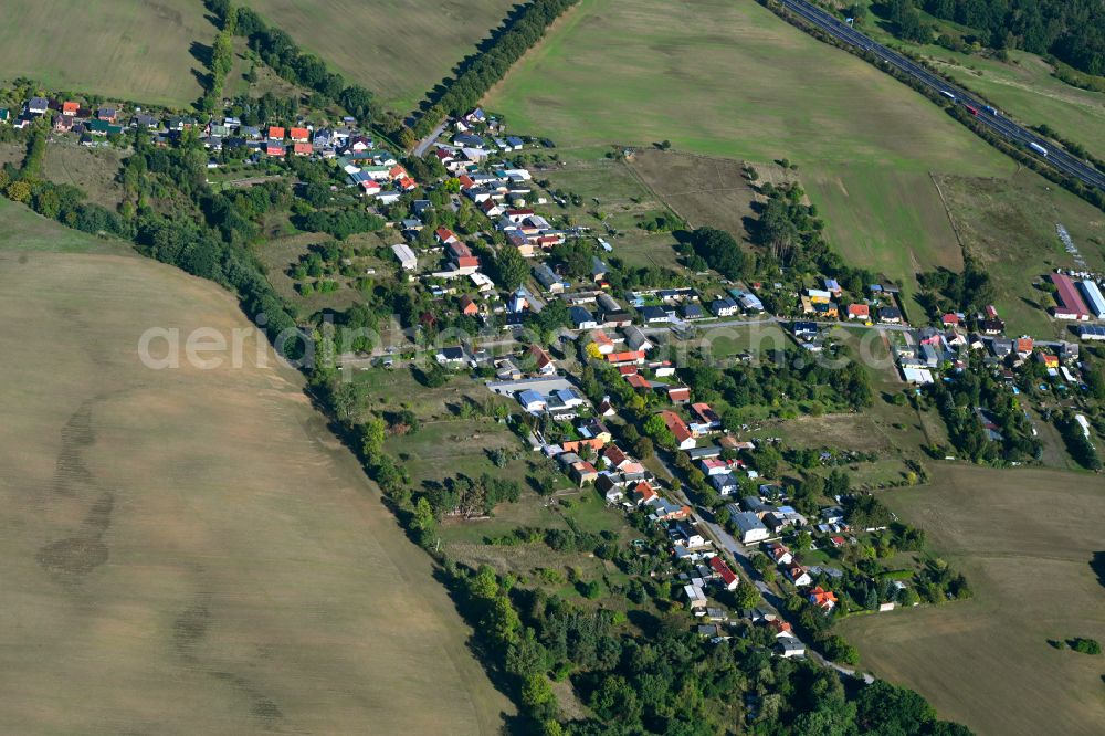 Werbellin from above - Agricultural land and field boundaries surround the settlement area of the village in Werbellin at Schorfheide in the state Brandenburg, Germany