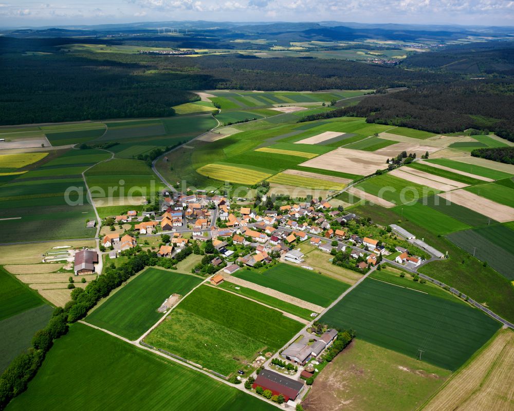 Wernges from above - Agricultural land and field boundaries surround the settlement area of the village in Wernges in the state Hesse, Germany