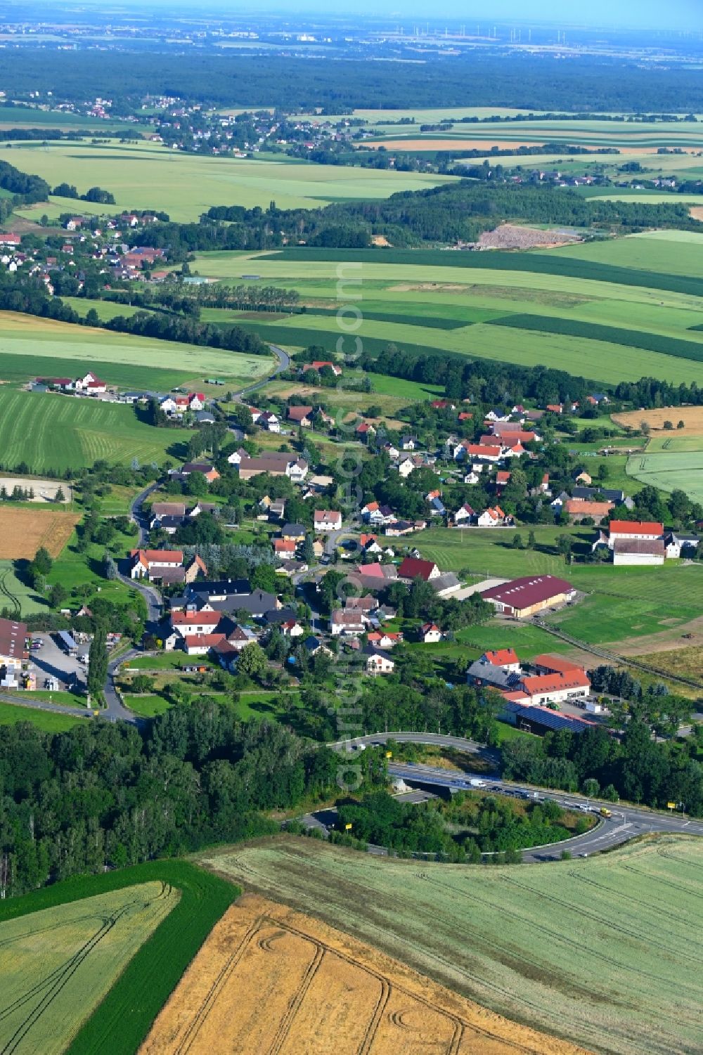 Wernsdorf from above - Agricultural land and field boundaries surround the settlement area of the village in Wernsdorf in the state Saxony, Germany