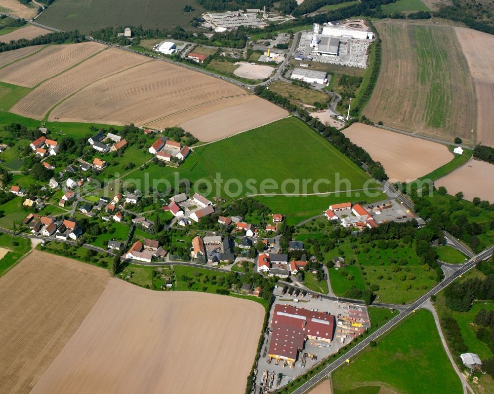 Wernsdorf from the bird's eye view: Agricultural land and field boundaries surround the settlement area of the village in Wernsdorf in the state Saxony, Germany