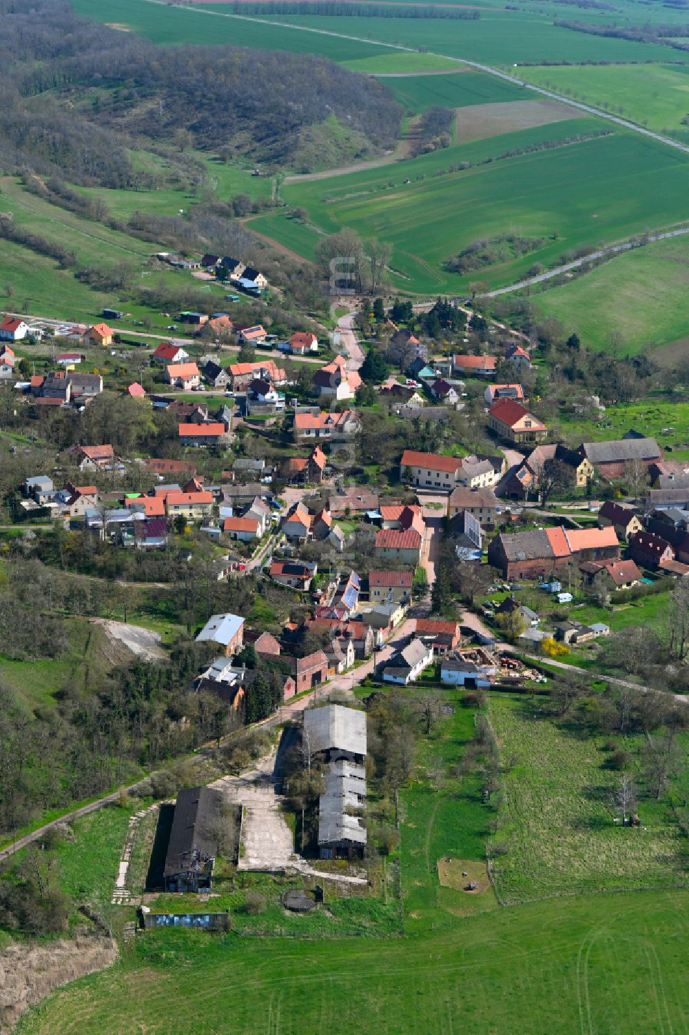 Wettin from above - Agricultural land and field boundaries surround the settlement area of the village in Wettin in the state Saxony-Anhalt, Germany