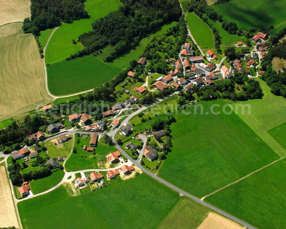 Wetzelsberg from above - Agricultural land and field boundaries surround the settlement area of the village in Wetzelsberg in the state Bavaria, Germany