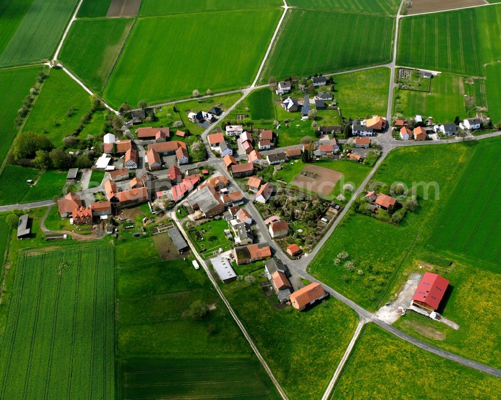 Aerial image Wetzlos - Agricultural land and field boundaries surround the settlement area of the village in Wetzlos in the state Hesse, Germany