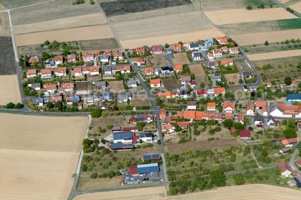 Weyersfeld from above - Agricultural land and field boundaries surround the settlement area of the village in Weyersfeld in the state Bavaria, Germany