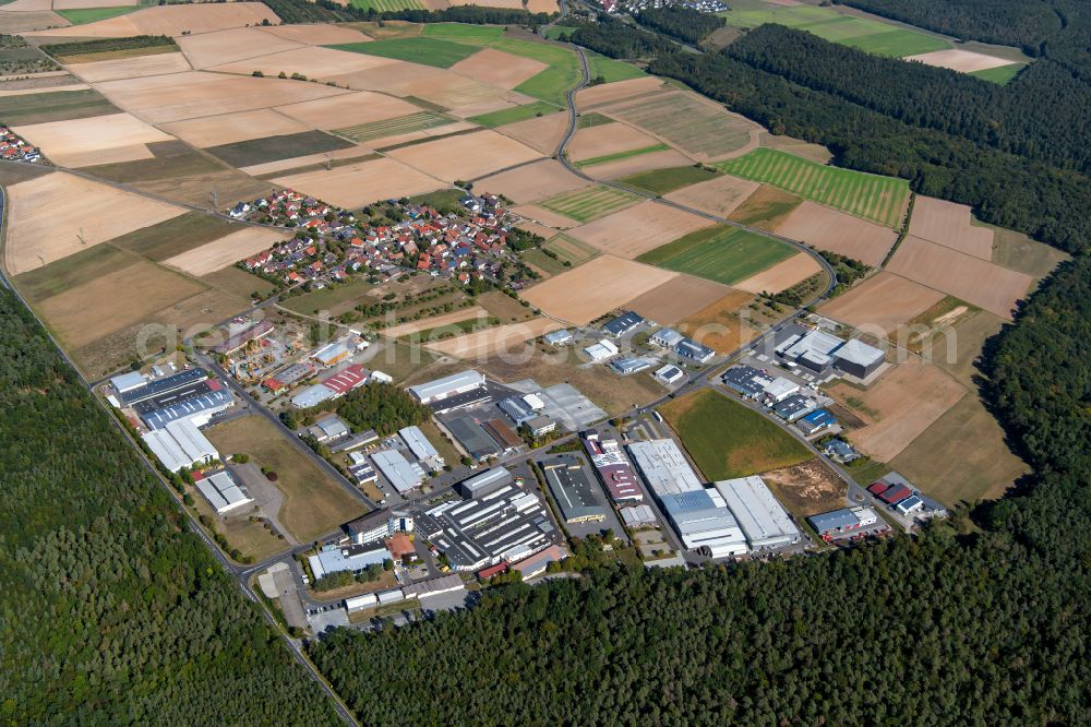 Wiebelbach from above - Agricultural land and field boundaries surround the settlement area of the village in Wiebelbach in the state Bavaria, Germany