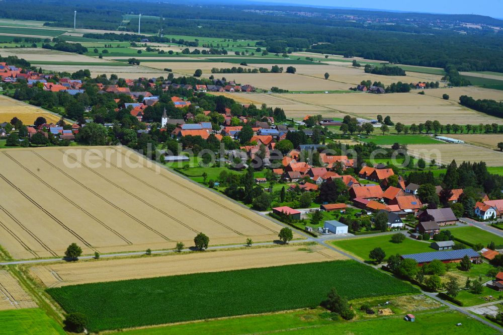 Wiedensahl from above - Agricultural land and field boundaries surround the settlement area of the village in Wiedensahl in the state Lower Saxony, Germany