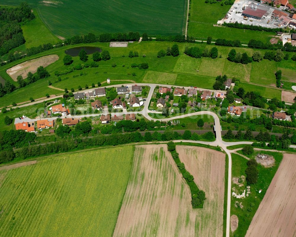 Wiedersbach from above - Agricultural land and field boundaries surround the settlement area of the village in Wiedersbach in the state Bavaria, Germany