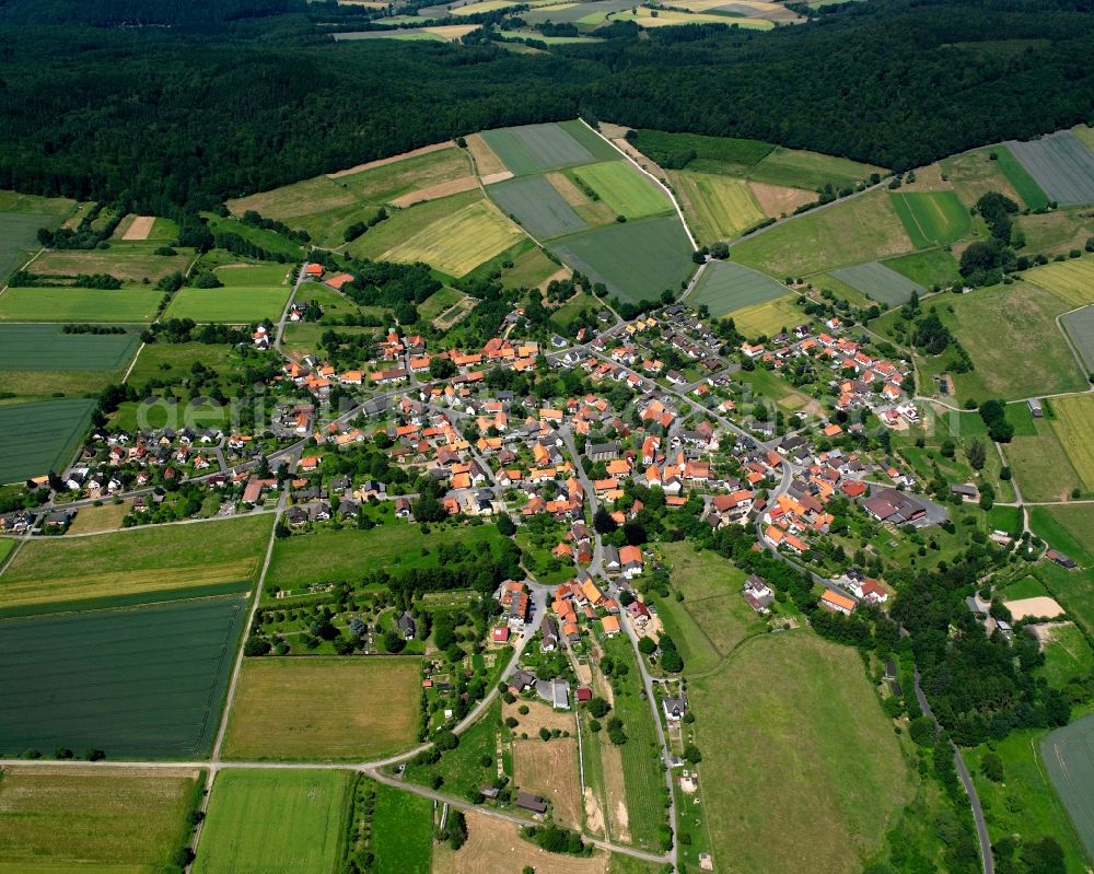 Wiershausen from above - Agricultural land and field boundaries surround the settlement area of the village in Wiershausen in the state Lower Saxony, Germany