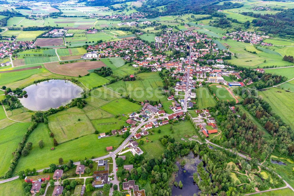 Aerial image Wilhelmsdorf - Agricultural meadows surround the settlement area of the village von Wiesen around the Lengenweiler bog lake in Wilhelmsdorf in the state Baden-Wuerttemberg, Germany