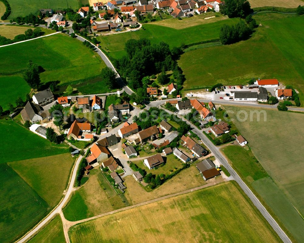 Wiesethbruck from above - Agricultural land and field boundaries surround the settlement area of the village in Wiesethbruck in the state Bavaria, Germany