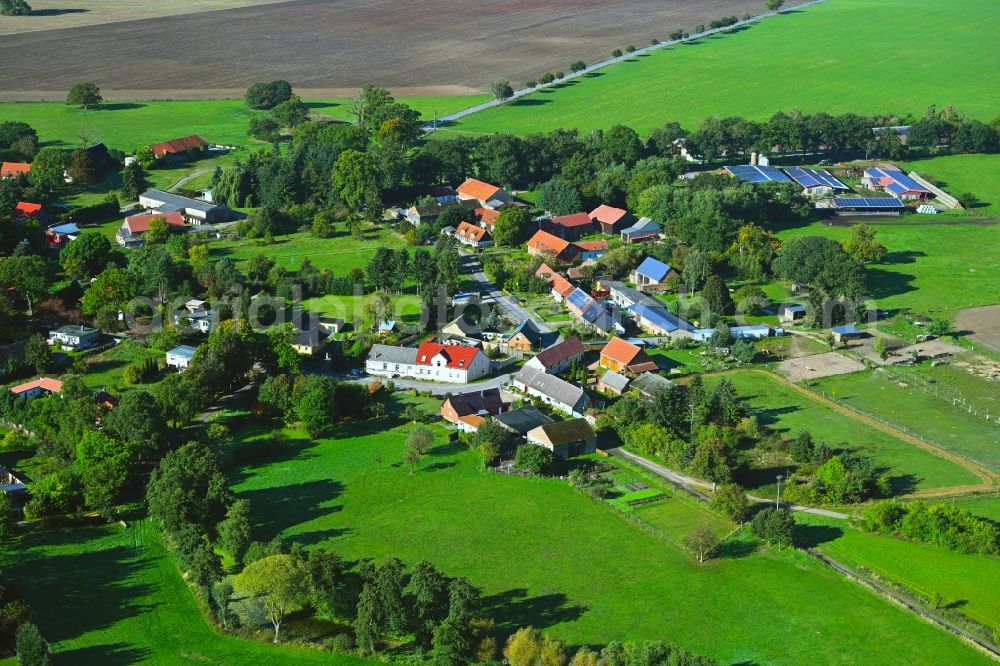 Aerial image Wilmersdorf - Agricultural land and field boundaries surround the settlement area of the village in Wilmersdorf in the state Brandenburg, Germany