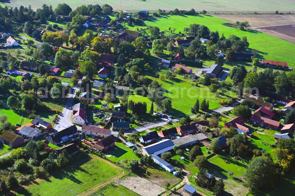 Wilmersdorf from above - Agricultural land and field boundaries surround the settlement area of the village in Wilmersdorf in the state Brandenburg, Germany