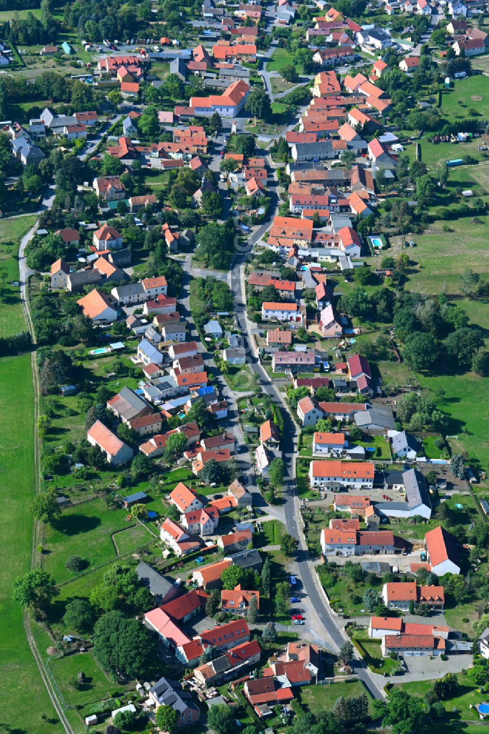 Wilschdorf from the bird's eye view: Agricultural land and field boundaries surround the settlement area of the village on street Kirchstrasse in Wilschdorf in the state Saxony, Germany