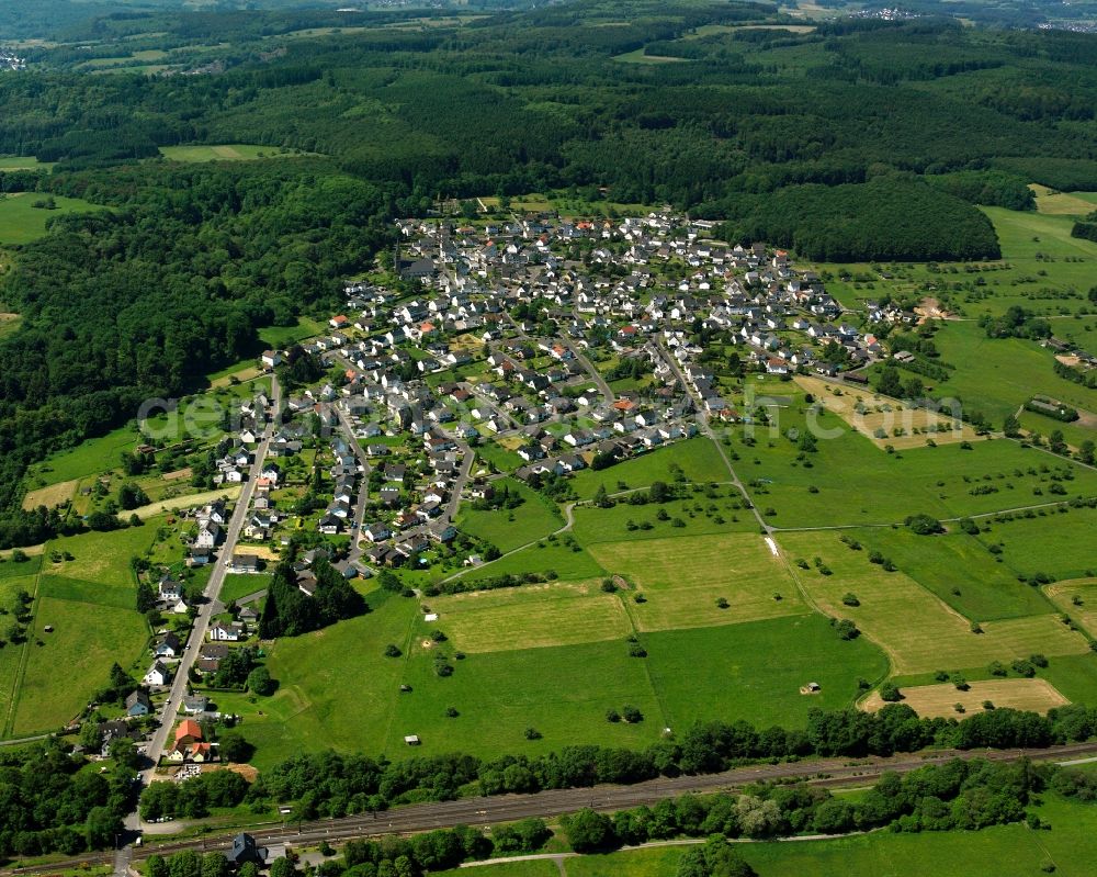 Wilsenroth from the bird's eye view: Agricultural land and field boundaries surround the settlement area of the village in Wilsenroth in the state Hesse, Germany