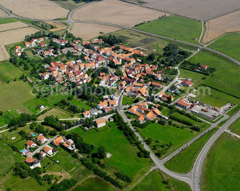 Windeberg from above - Agricultural land and field boundaries surround the settlement area of the village in Windeberg in the state Thuringia, Germany