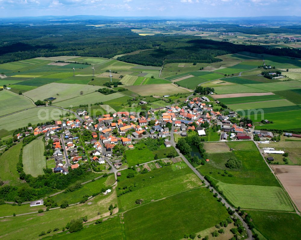 Aerial image Windhausen - Agricultural land and field boundaries surround the settlement area of the village in Windhausen in the state Hesse, Germany