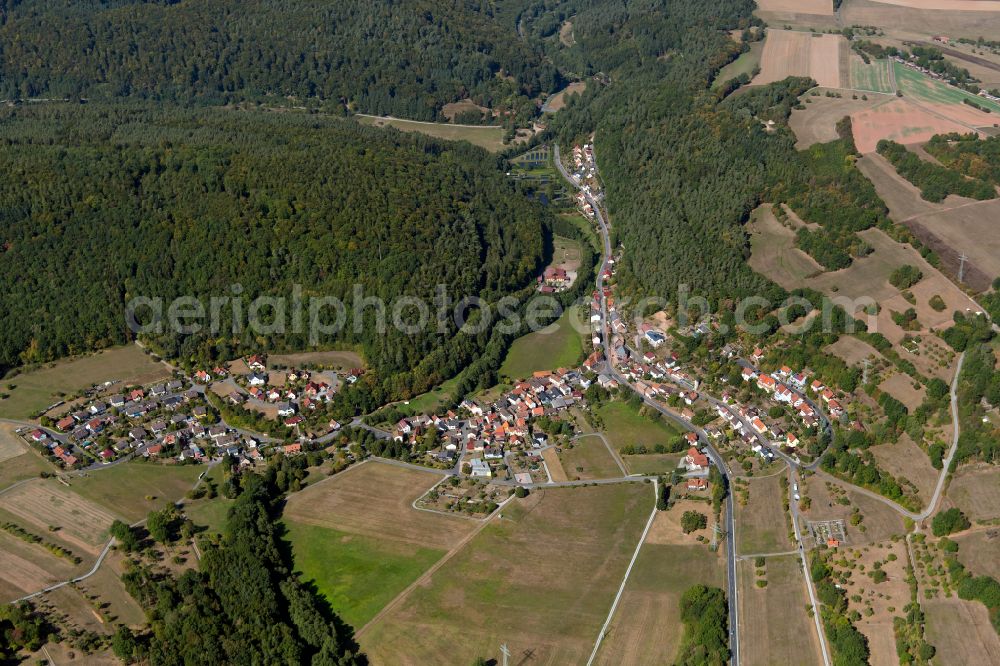 Windheim from above - Agricultural land and field boundaries surround the settlement area of the village in Windheim in the state Bavaria, Germany