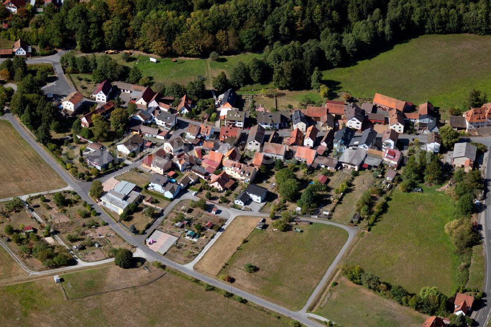 Windheim from the bird's eye view: Agricultural land and field boundaries surround the settlement area of the village in Windheim in the state Bavaria, Germany