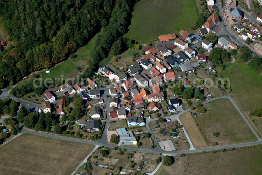 Windheim from above - Agricultural land and field boundaries surround the settlement area of the village in Windheim in the state Bavaria, Germany