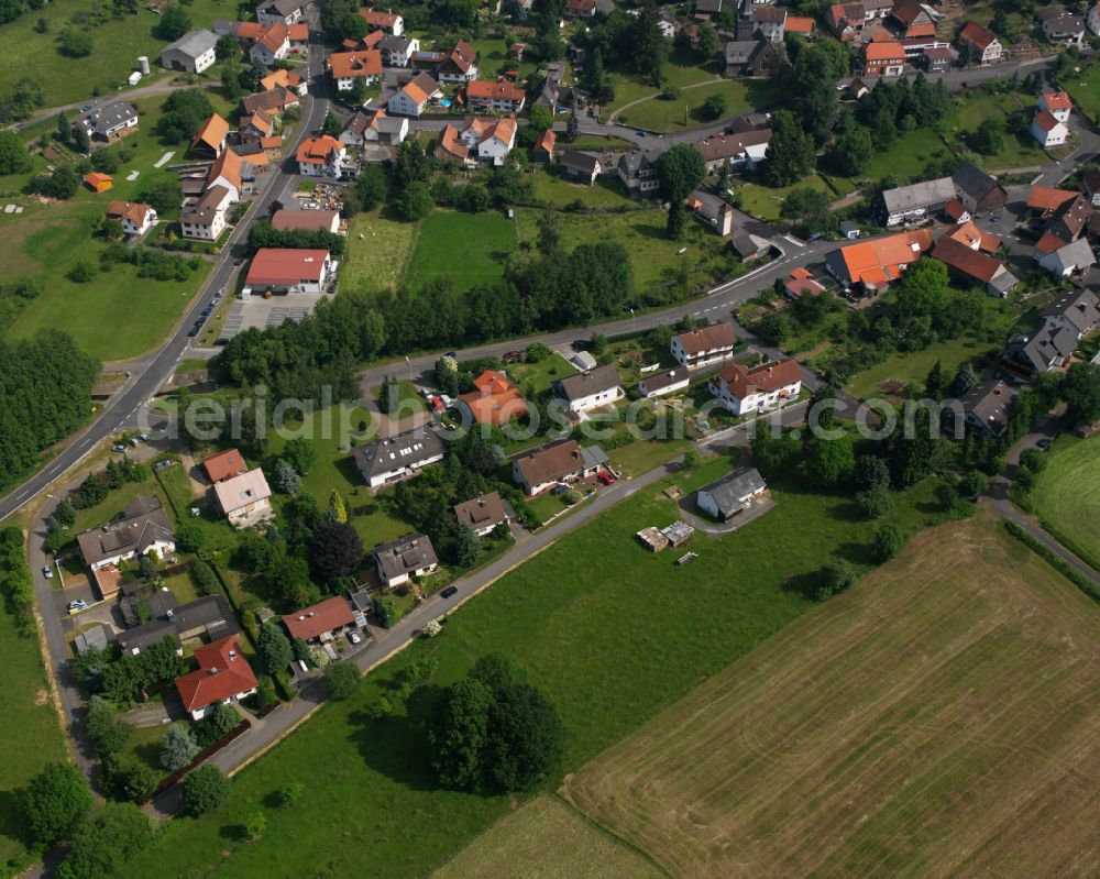 Aerial image Wingershausen - Agricultural land and field boundaries surround the settlement area of the village in Wingershausen in the state Hesse, Germany