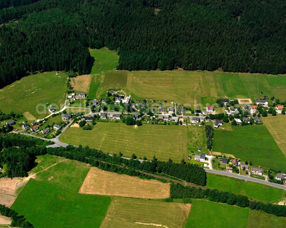 Wingeshausen from above - Agricultural land and field boundaries surround the settlement area of the village in Wingeshausen in the state North Rhine-Westphalia, Germany