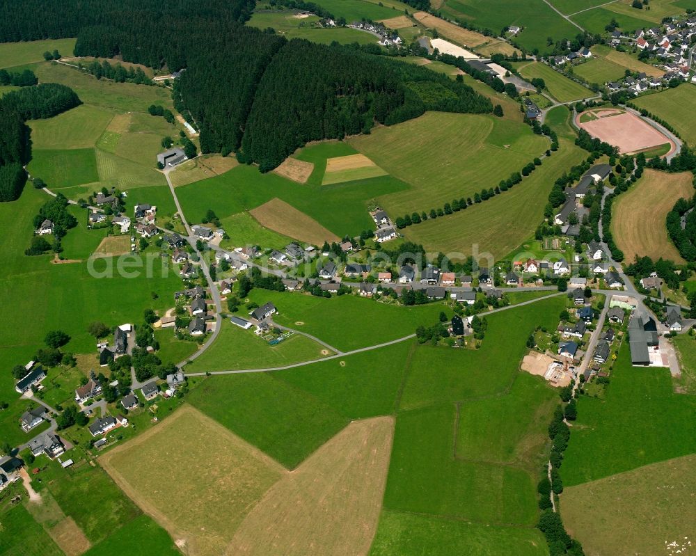 Wingeshausen from the bird's eye view: Agricultural land and field boundaries surround the settlement area of the village in Wingeshausen in the state North Rhine-Westphalia, Germany