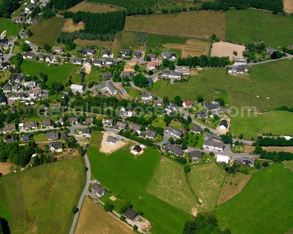 Aerial image Wingeshausen - Agricultural land and field boundaries surround the settlement area of the village in Wingeshausen in the state North Rhine-Westphalia, Germany