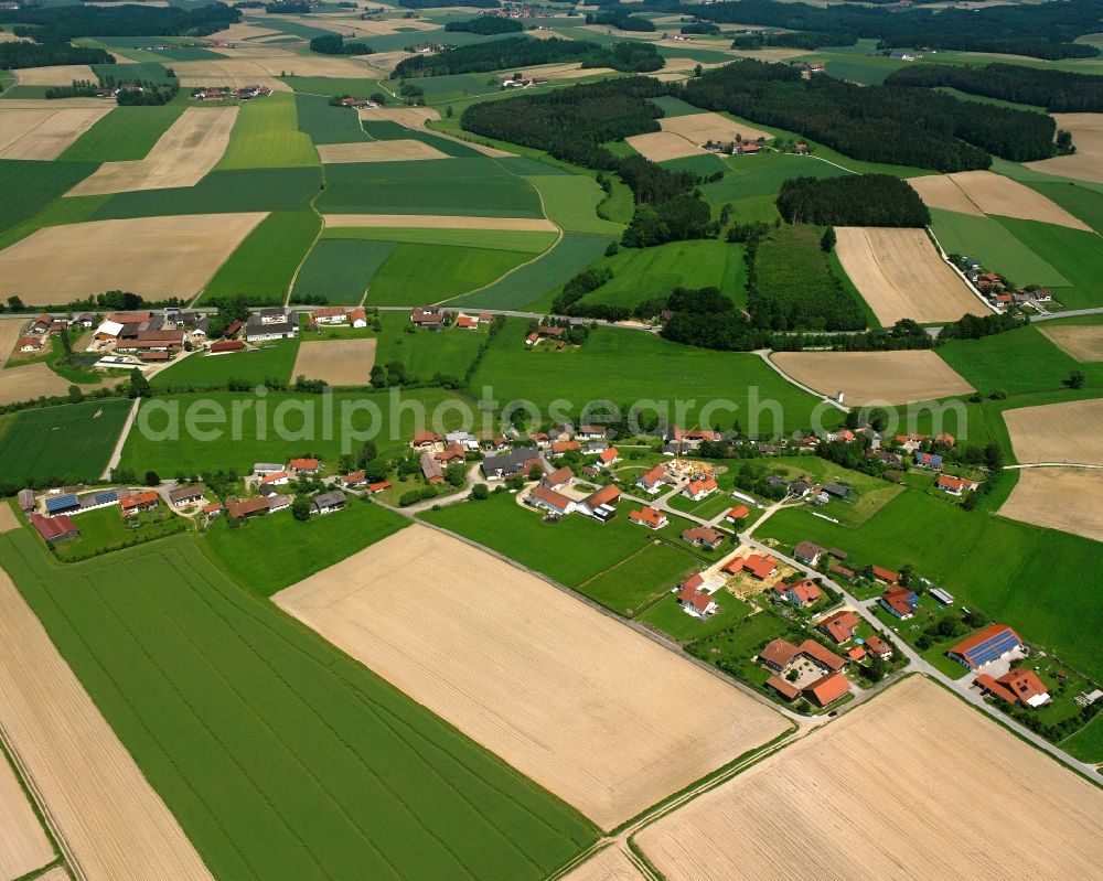 Wolfsegg from above - Agricultural land and field boundaries surround the settlement area of the village in Wolfsegg in the state Bavaria, Germany