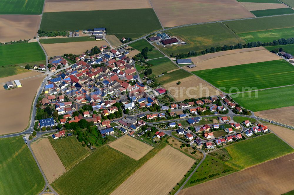 Aerial image Wolkshausen - Agricultural land and field boundaries surround the settlement area of the village in Wolkshausen in the state Bavaria, Germany