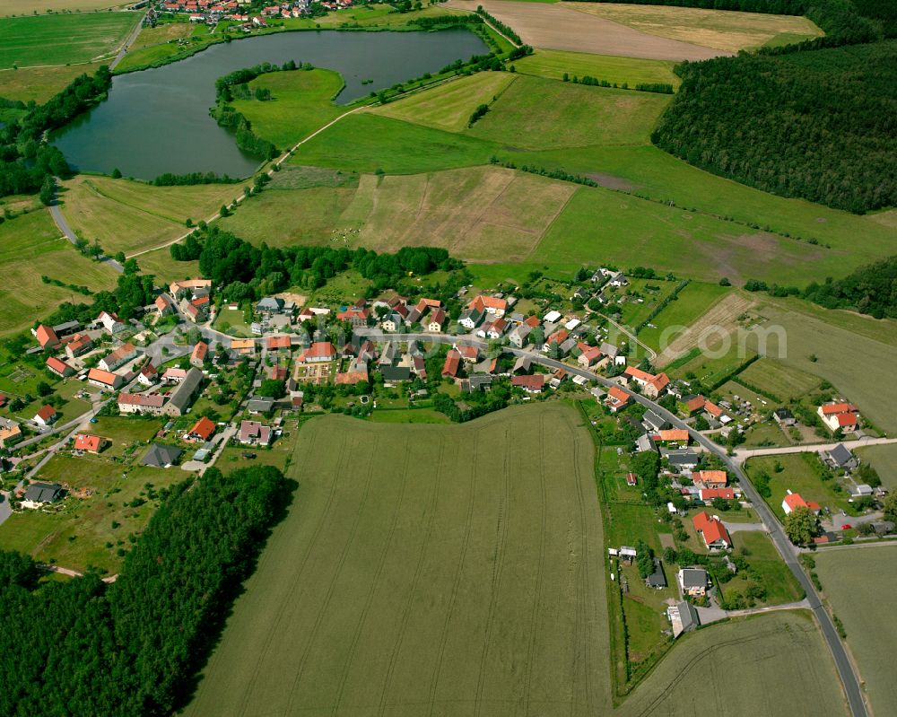 Würschnitz from above - Agricultural land and field boundaries surround the settlement area of the village in Würschnitz in the state Saxony, Germany