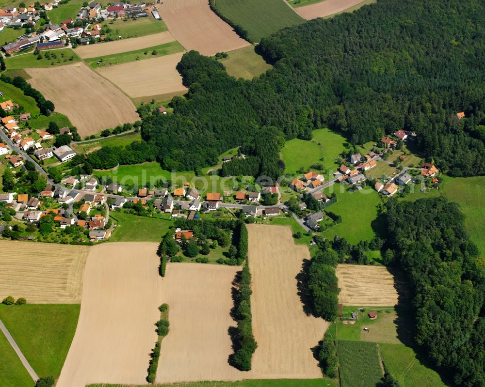 Würzberg from above - Agricultural land and field boundaries surround the settlement area of the village in Würzberg in the state Hesse, Germany