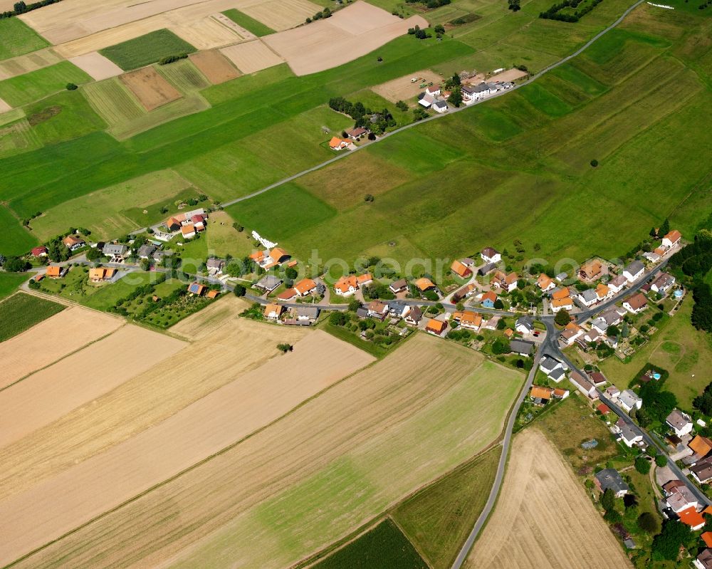 Würzberg from the bird's eye view: Agricultural land and field boundaries surround the settlement area of the village in Würzberg in the state Hesse, Germany