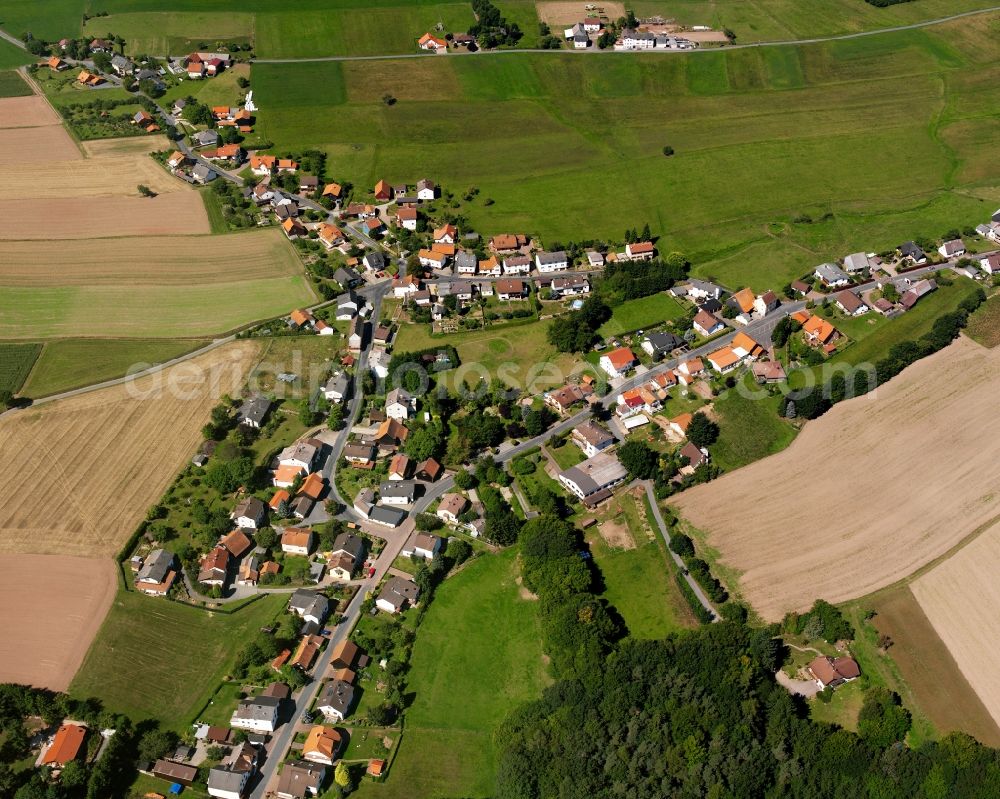 Aerial photograph Würzberg - Agricultural land and field boundaries surround the settlement area of the village in Würzberg in the state Hesse, Germany