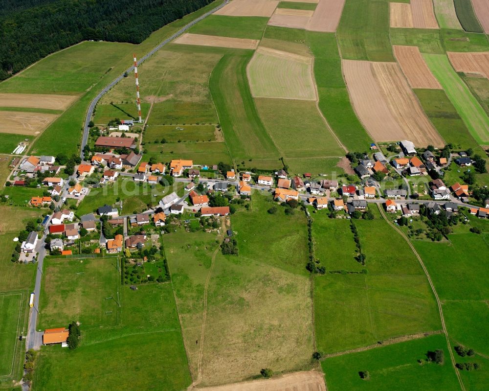 Würzberg from above - Agricultural land and field boundaries surround the settlement area of the village in Würzberg in the state Hesse, Germany