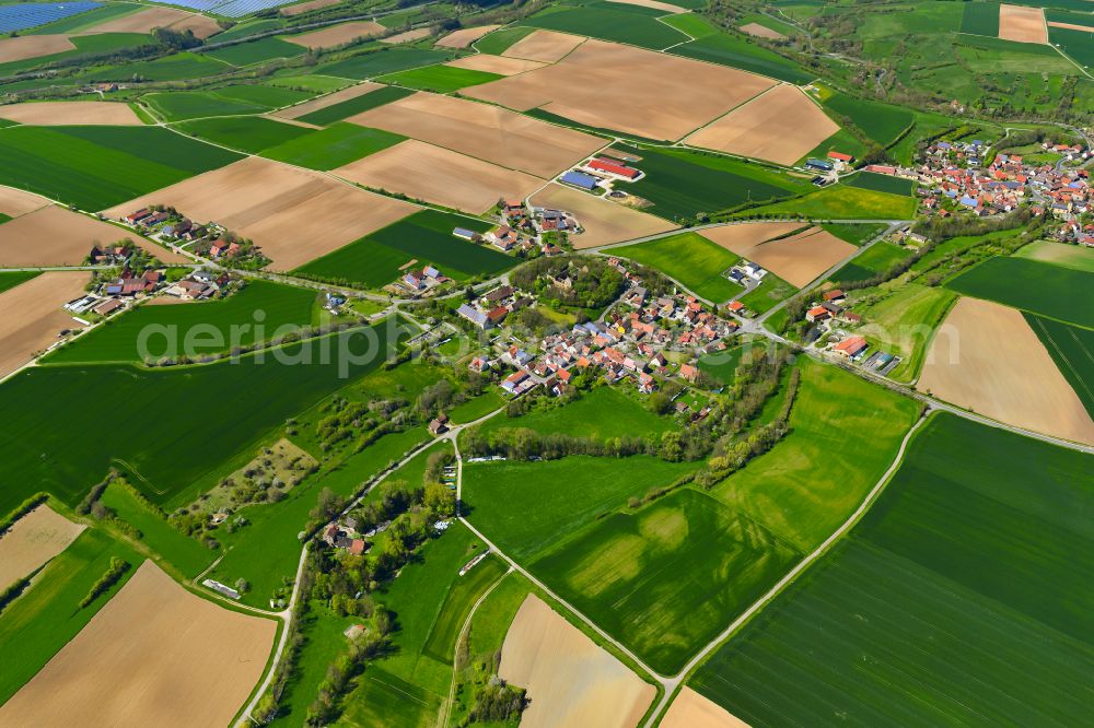 Wässerndorf from above - Agricultural land and field boundaries surround the settlement area of the village in Wässerndorf in the state Bavaria, Germany