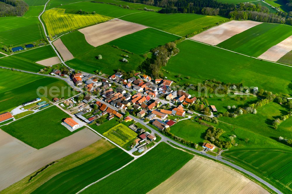 Wüstenfelden from the bird's eye view: Agricultural land and field boundaries surround the settlement area of the village in Wüstenfelden in the state Bavaria, Germany