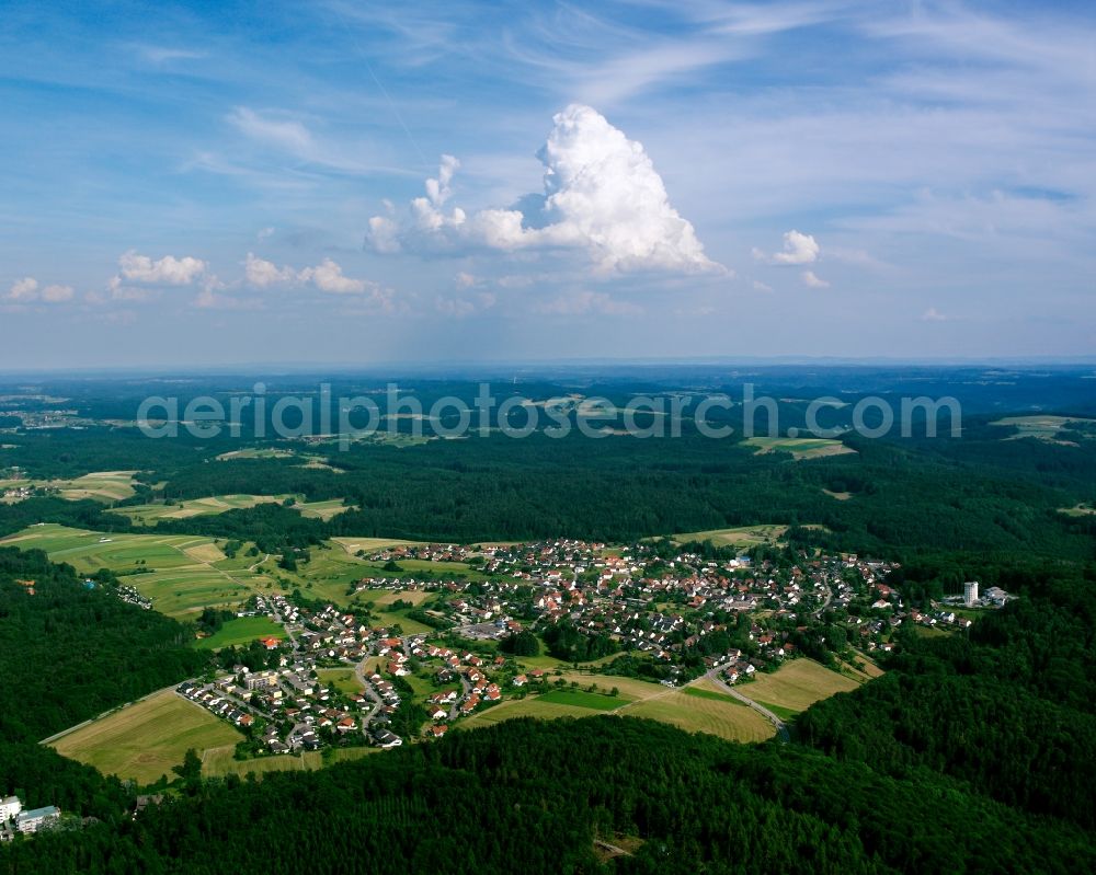 Wüstenrot from the bird's eye view: Agricultural land and field boundaries surround the settlement area of the village in Wüstenrot in the state Baden-Wuerttemberg, Germany