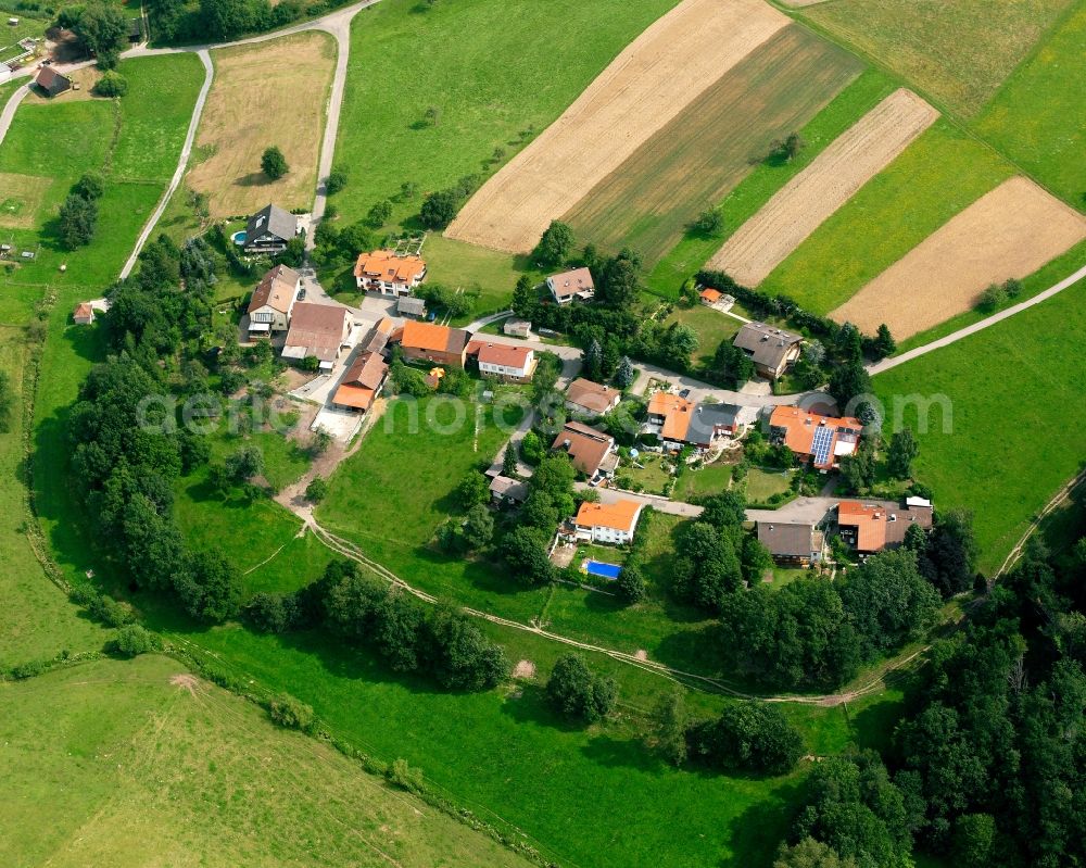 Wüstenrot from the bird's eye view: Agricultural land and field boundaries surround the settlement area of the village in Wüstenrot in the state Baden-Wuerttemberg, Germany