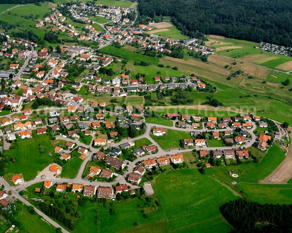 Wüstenrot from the bird's eye view: Agricultural land and field boundaries surround the settlement area of the village in Wüstenrot in the state Baden-Wuerttemberg, Germany