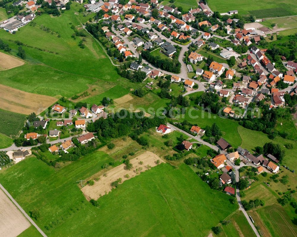 Wüstenrot from above - Agricultural land and field boundaries surround the settlement area of the village in Wüstenrot in the state Baden-Wuerttemberg, Germany